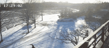 a car is parked in the snow with the time of 17:29 on the bottom