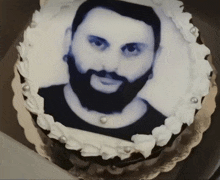 a cake with a picture of a man with a beard on top