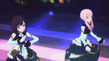 two anime girls are dancing on a stage .