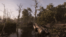 a person holding a gun in the middle of a forest