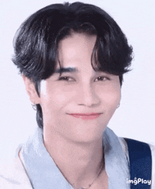 a close up of a person 's face with a smile on his face .