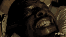 a close up of a man 's face with the words imgplay visible