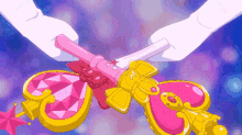 a person is holding a pink and yellow item