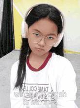 a girl wearing headphones and a shirt that says ' when my crush is here > < '