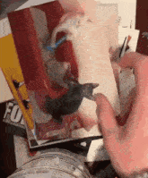 a person holding a piece of paper with a picture of a cat on it