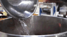 water is being poured into a pot that says made in animatica on the bottom