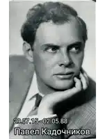 a black and white photo of a man with his hand on his chin