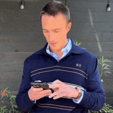 a man wearing a blue sweater with the letter g on it