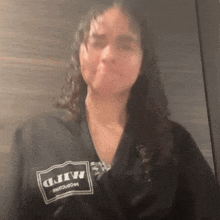 a woman wearing a black shirt that says mfd on it