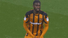 a soccer player wears a jersey that says sportpesa on it