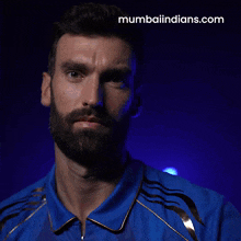 a man wearing a blue shirt that says idfc first bank on it