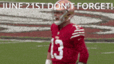 a football player in a red jersey with the number 13