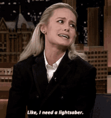a woman in a tuxedo says " like i need a lightsaber "