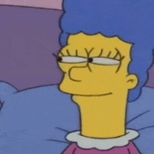 a close up of a cartoon character laying in bed with glasses on .