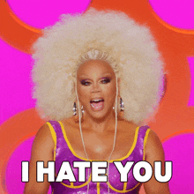 a drag queen with a large afro says " i hate you "