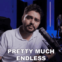 a man with a beard stands in front of a microphone and says " pretty much endless "