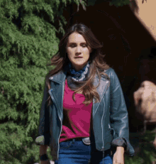 a woman wearing a leather jacket and a bandana
