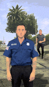 a man in a blue shirt with officer on the front