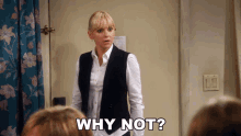 a woman is standing in front of a door and says why not