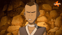 a cartoon character from nickelodeon is standing in front of rocks