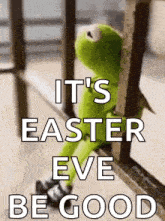 kermit the frog is sitting on a railing with the words `` it 's easter eve be good '' written above him .