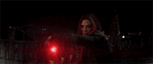 a dark room with a red light shining through the window