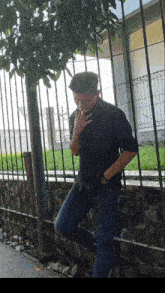 a man in a black shirt smoking a cigarette