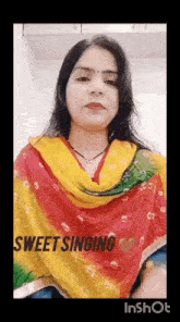 a woman wearing a colorful scarf and a necklace is singing .