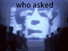 a group of people looking at a screen with the words who asked on it