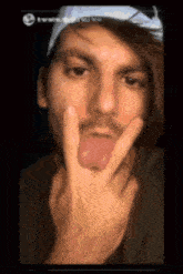 a man making a peace sign with his fingers
