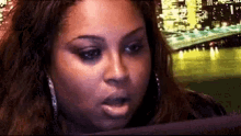 a woman with a surprised look on her face is looking at a tablet .