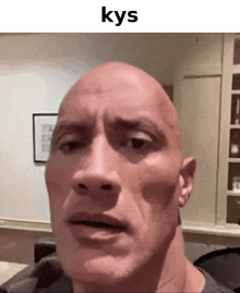 a close up of a bald man 's face with the words kys written above him .