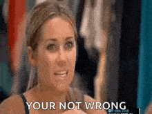 a woman is saying `` your not wrong '' while standing in front of a closet .