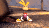 a cartoon character is sitting on a wooden floor in a room .