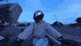 a person wearing a helmet is riding a motorcycle