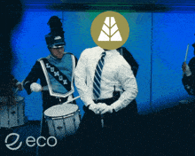a man in a marching band playing drums with the word eco in the bottom right