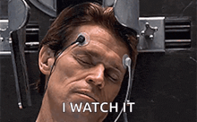 a man with headphones on his head and the words `` i watch it '' on the bottom .