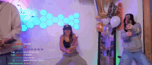 a man and a woman are standing next to each other in front of balloons and a mirror .