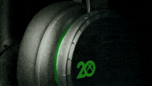 a close up of a green microphone on a black headset
