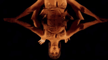 a woman in a bra is laying on her back with her hands on her chest .