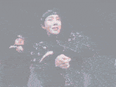a blurry picture of a woman standing in a room