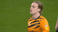 a soccer player wearing a yellow jersey that says sky