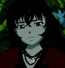 a girl with black hair and red eyes is wearing a necklace that says 3 on it .