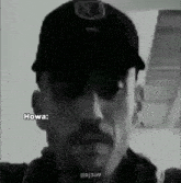 a black and white photo of a man wearing a hat and sunglasses with the caption howa