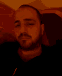 a man with a beard is wearing a black shirt with the word nike on the front