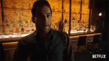 a man is standing in front of a bar with a netflix logo in the corner