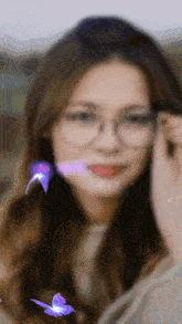 a woman wearing glasses with purple butterflies flying around her face