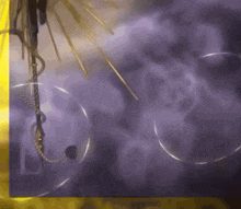 a purple background with a few circles and a rope hanging from it