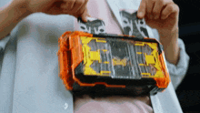 a close up of a person holding a toy that says ' a ' on the front