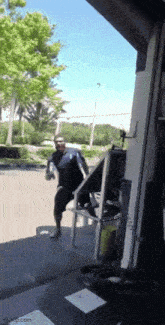 a man is walking down stairs in front of a garage door .
